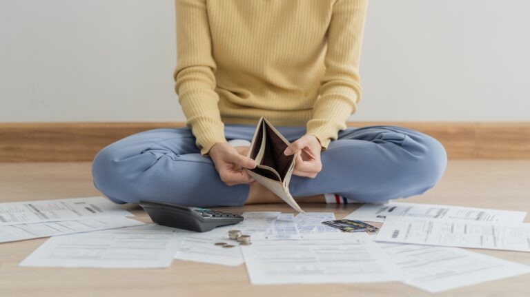woman holding and open empty wallet