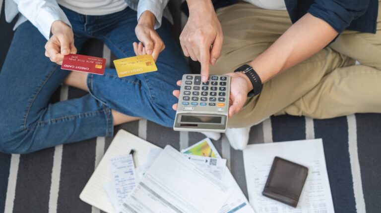couple calculates expense from credit cards