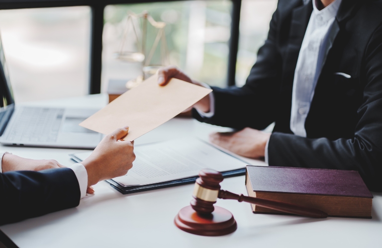 the lawyer hands over the document to the client