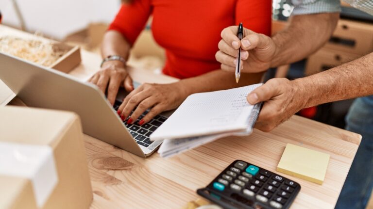 Middle aged man and woman are calculating expenses